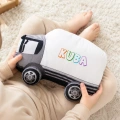 Poduszka w kształcie samochodu ciężarowego z imieniem dziecka.