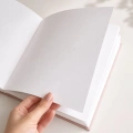 Białe karty księgi gości, wnętrze welurowej księgi gości, grube kartki albumu, księga gości na zdjęcia i wpisy, album z pustymi stronami.