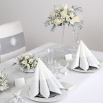 Zestaw papierowych serwetek w kolorze białym, ze srebrnym zdobieniem w postaci ażurowego wzoru. Elegancka ozdoba stołu.
