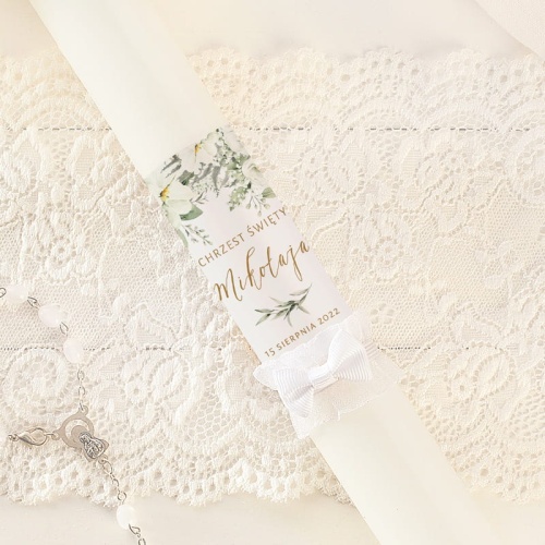 Personalizowana gromnica na Chrzciny dziecka w białym kolorze, wzbogacona o kwiatowy motyw w jasnej kolorystyce.